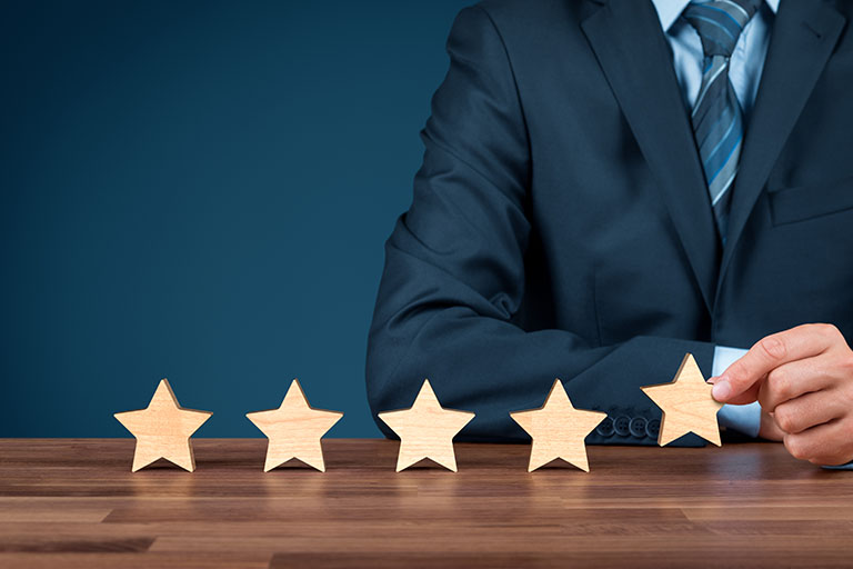 Photo of a man in a suit with 5 wooden stars