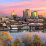 The Sacramento skyline and Tower Bridge at sunset with reflections in the water