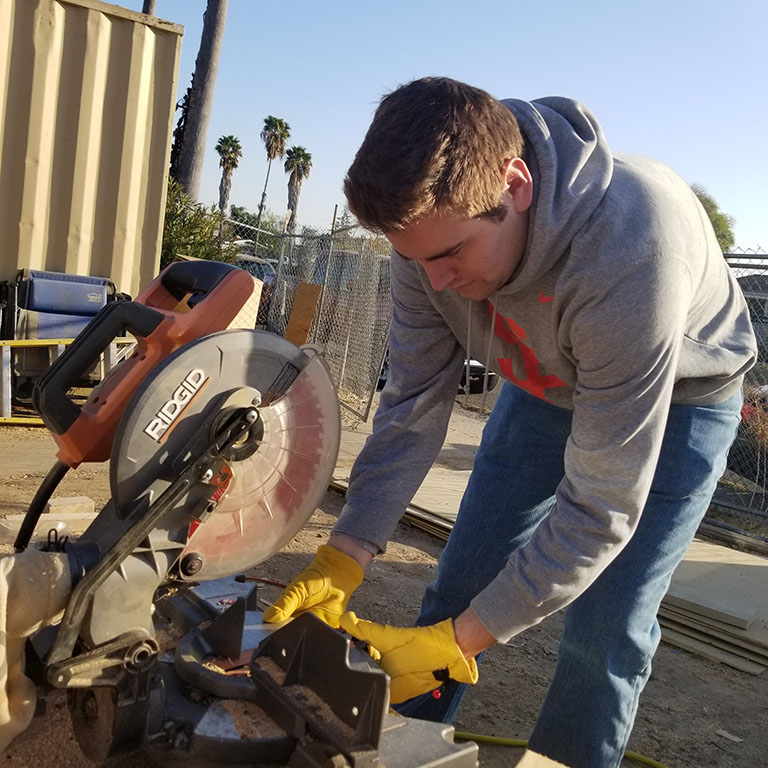 Kevin Olson cutting wood for the house build