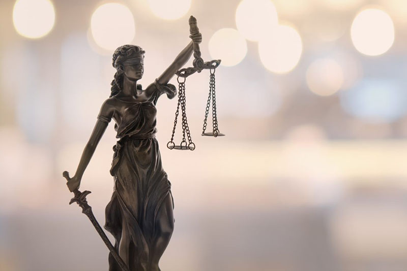 Photo of a statue of Lady Justice blindfolded and holding scales