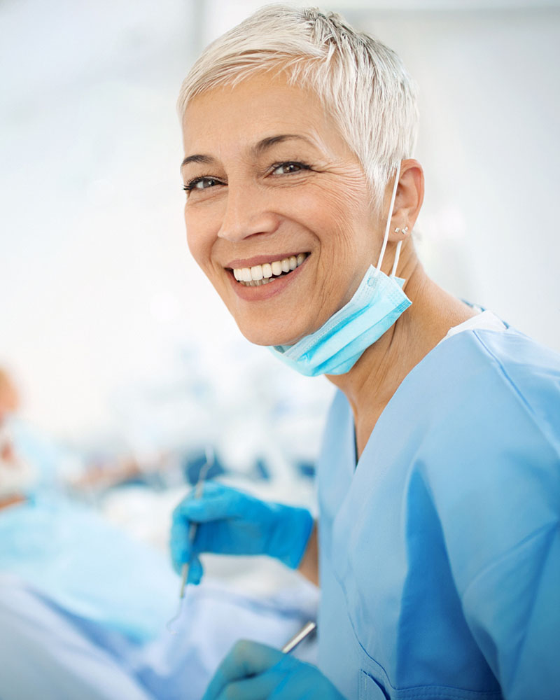 Photo of dentist smiling for dental marketing benefits.