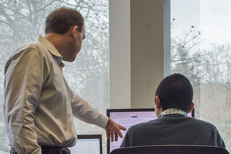 Photo of two Capitol Tech Solutions software engineers mulling over an app development project.