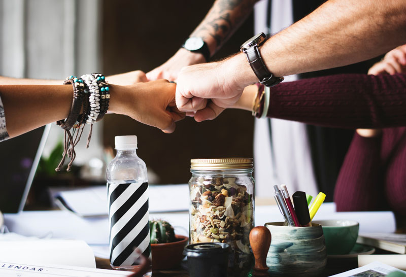 Photo of team fist bump by rawpixel.com on Unsplash