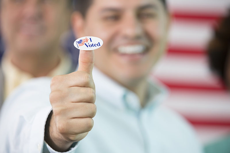 Photo of man with a thumbs up that just voted for a campaign. 